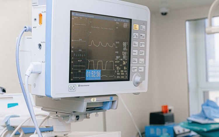 A patient monitor beside a hospital bed — medical electronics