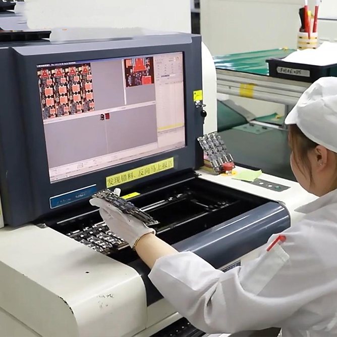 An operator reviewing board images on an automated optical inspection station