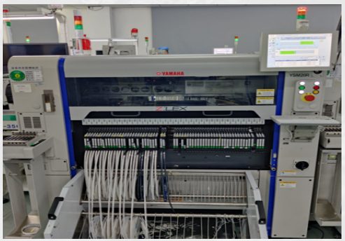 Component tape feeders loaded with reels on a Yamaha pick-and-place machine